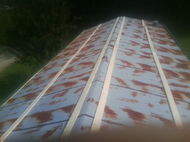 Rusted metal roof panels with new wood purlins before replacement — Storm Damage Roof Repair in Rising Fawn by Roofing Brothers