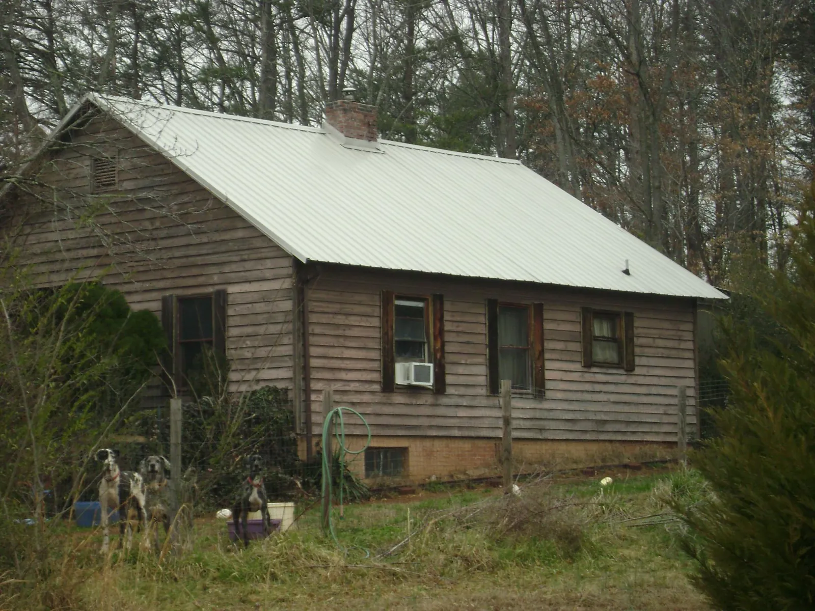 White metal roof on an old wood sided farmhouse, from a Metal Roof Installation job in Rising Fawn